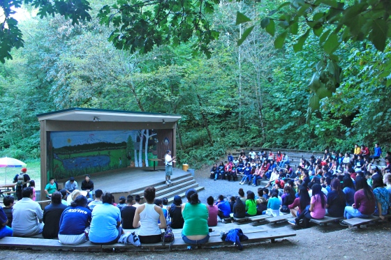 Students unite at amphitheater to hear Mario's story as an undocumented farmer (camp coordinator)
